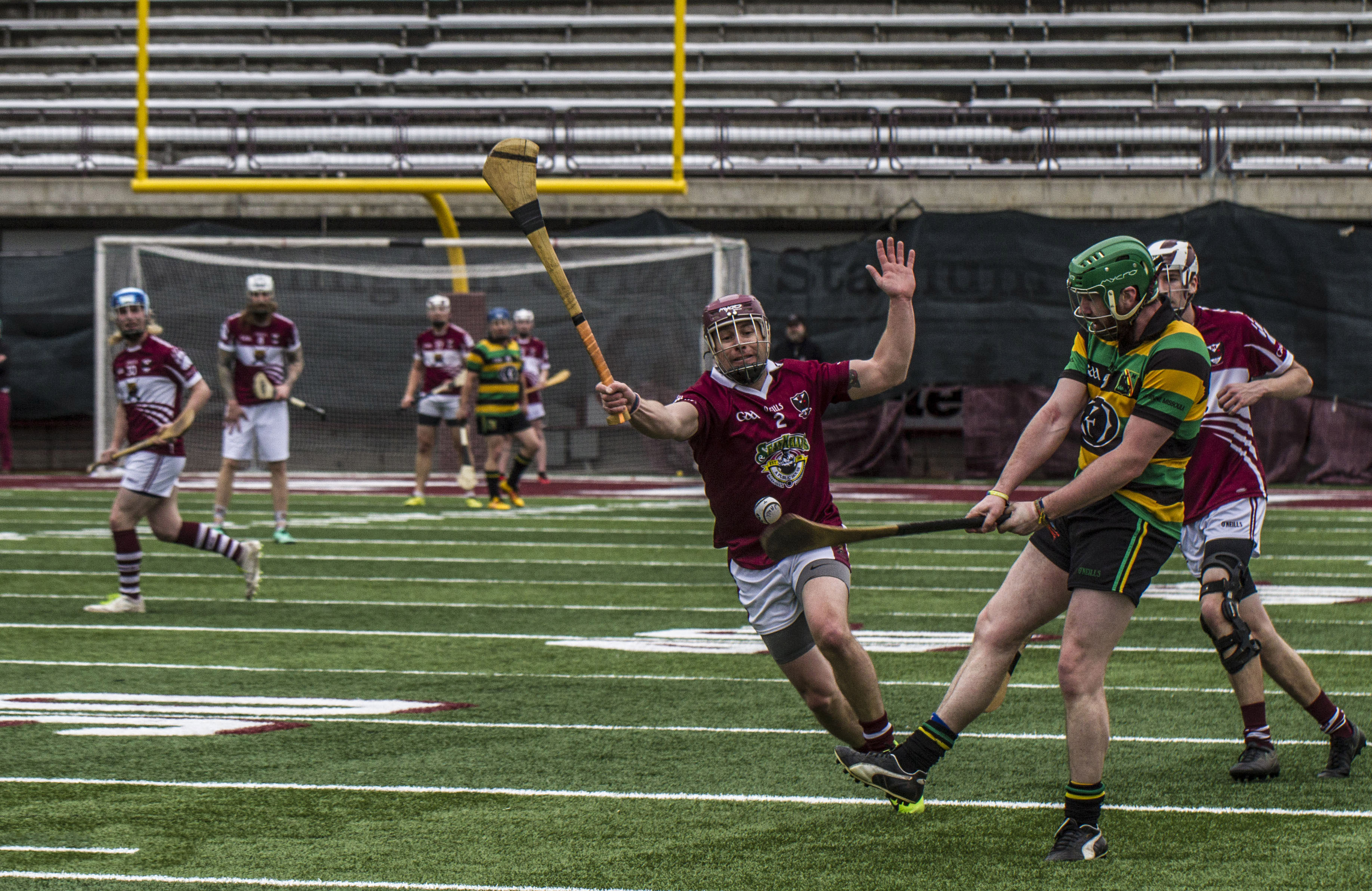 A group of college students playing a hurling game