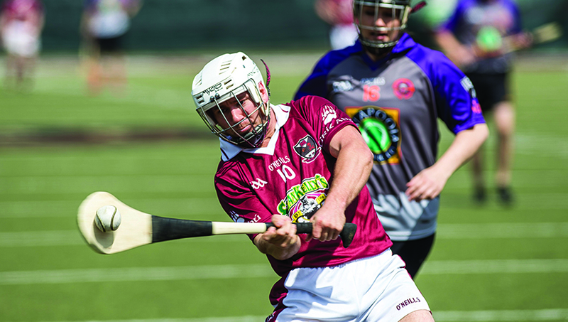 hurling player hitting ball