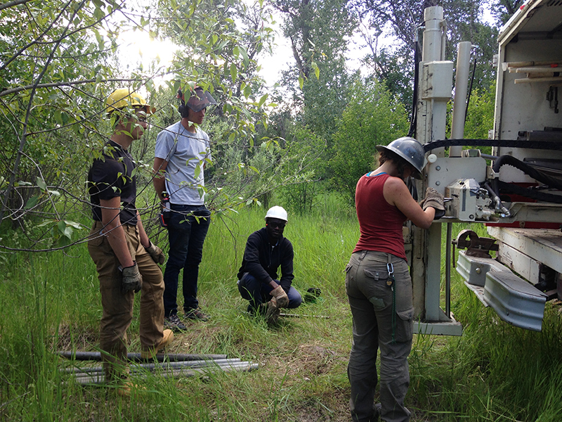 several people working with a geoprobe in the field
