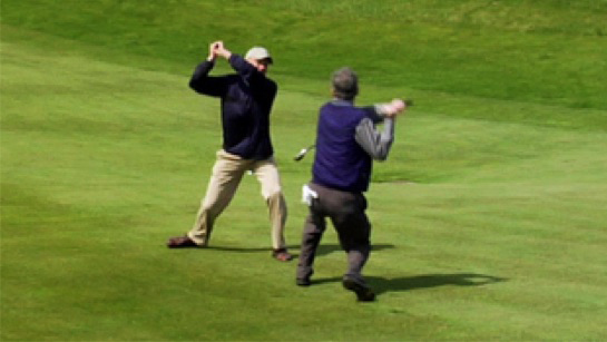 Aggressive male human attacks another male (golfing)